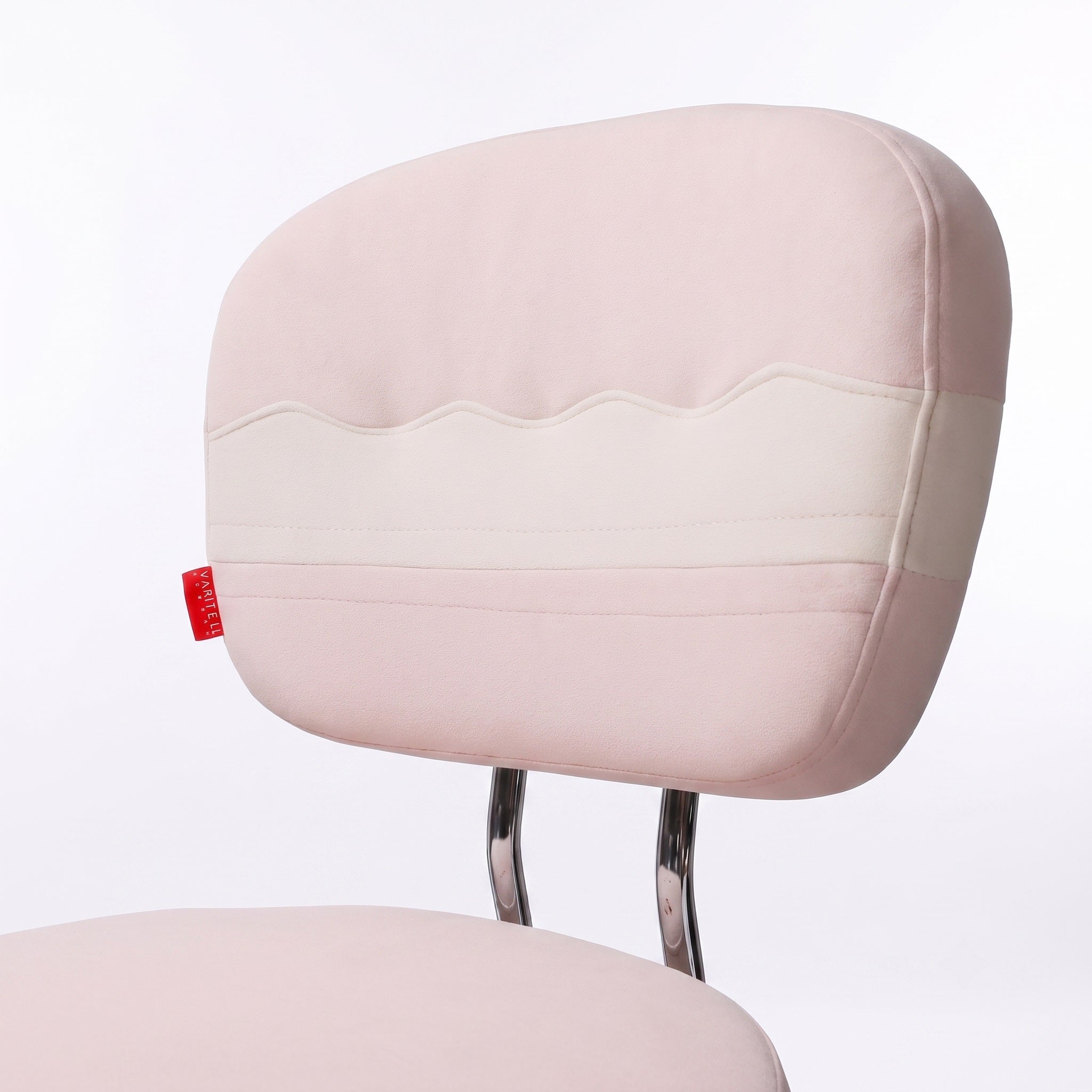 A close-up of a pink vanity chair backrest