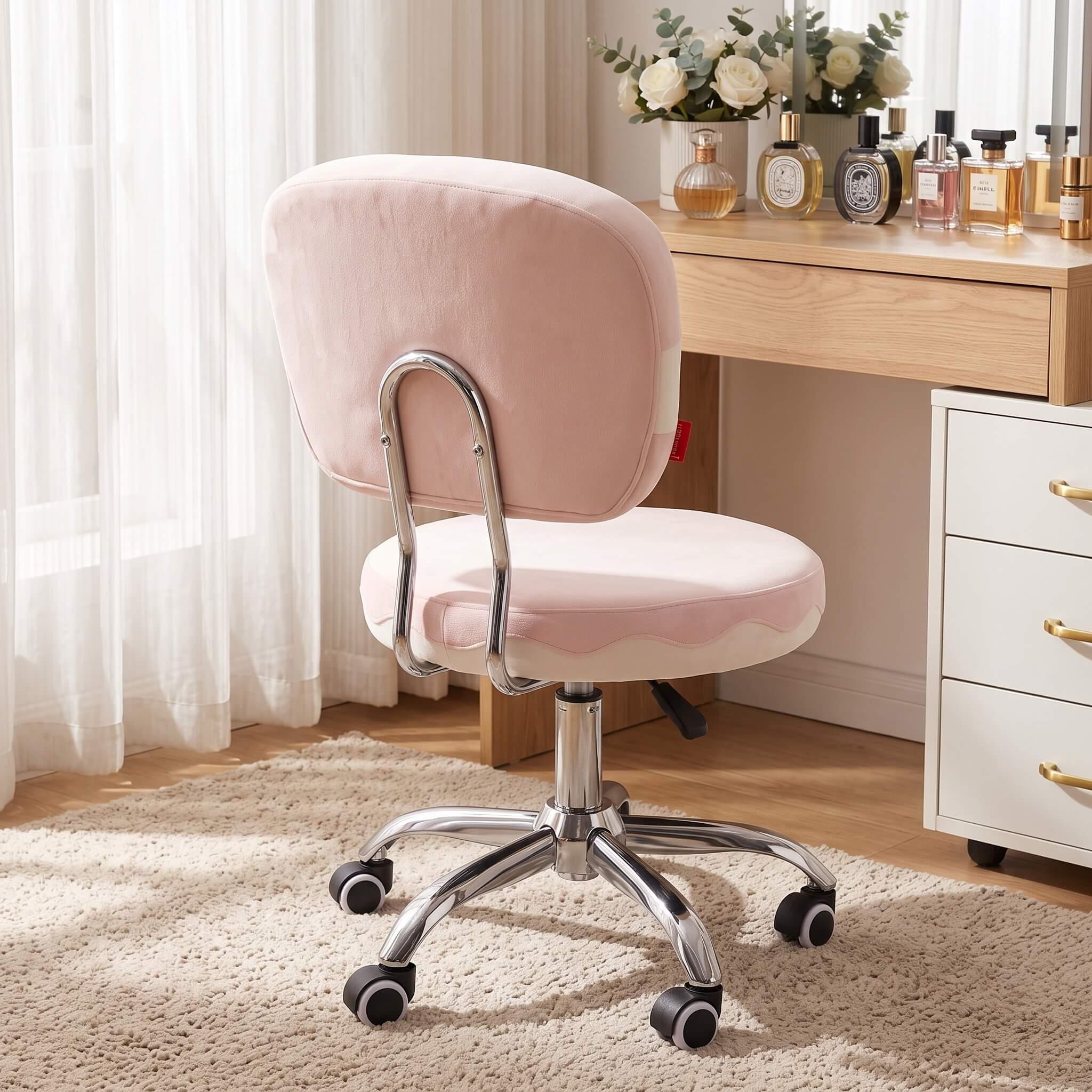 Back view of pink velvet swivel vanity chair in bedroom dressing area